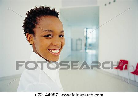Stock Photo - Businesswoman smiling in office. Fotosearch