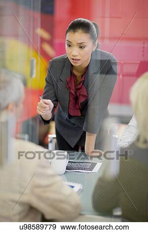 Stock Photo - Businesswoman talking in meeting. Fotosearch