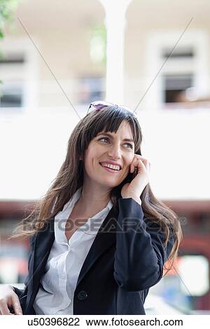 Businesswoman talking on cell phone View Large Photo Image Stock Image - Businesswoman talking on cell phone. Fotosearch