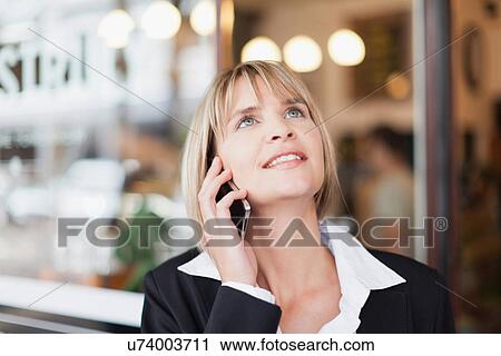 Stock Image - Businesswoman talking on cell phone. Fotosearch