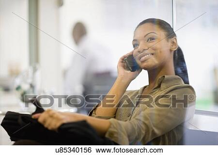 Businesswoman talking on cell phone View Large Photo Image Stock Photograph - Businesswoman talking on cell phone. Fotosearch