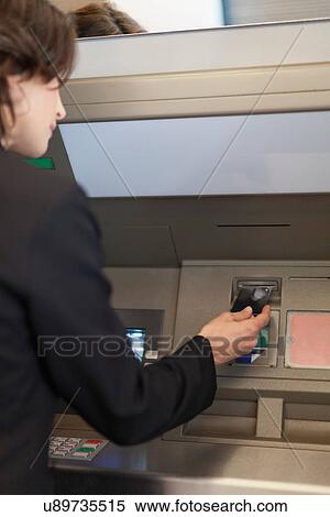 Businesswoman using ATM outdoors View Large Photo Image Stock Photography - Businesswoman using ATM outdoors. Fotosearch