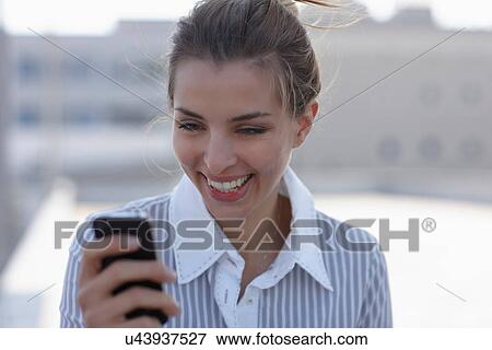 Businesswoman using cell phone View Large Photo Image Stock Photo - Businesswoman using cell phone. Fotosearch