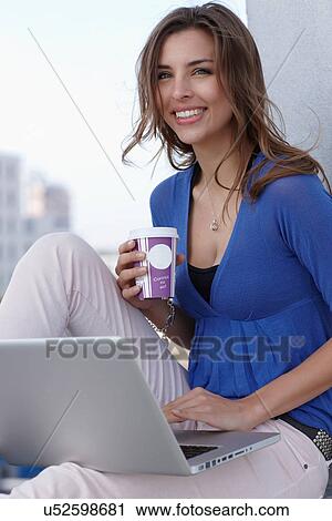Businesswoman using laptop on balcony View Large Photo Image Stock Image - Businesswoman using laptop on balcony. Fotosearch