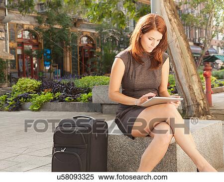 Stock Photography - Businesswoman using tablet computer. Fotosearch
