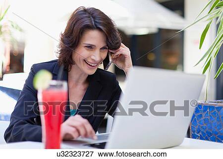 Businesswoman working in cafe View Large Photo Image Stock Photo - Businesswoman working in cafe. Fotosearch