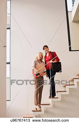 Businesswomen standing on steps View Large Photo Image Stock Image - Businesswomen standing on steps. Fotosearch
