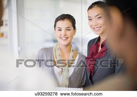 Businesswomen talking in office View Large Photo Image Stock Photo - Businesswomen talking in office. Fotosearch