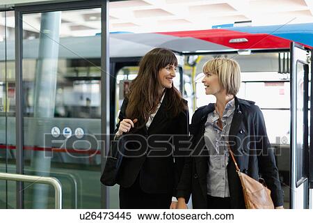 Businesswomen walking in bus station View Large Photo Image Stock Photography - Businesswomen walking in bus station. Fotosearch