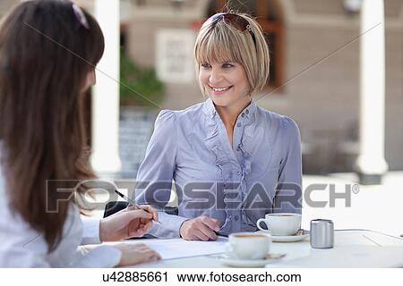Businesswomen working in cafe View Large Photo Image Stock Image - Businesswomen working in cafe. Fotosearch