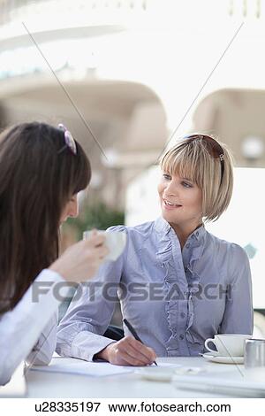 Businesswomen working in cafe View Large Photo Image Stock Photo - Businesswomen working in cafe. Fotosearch