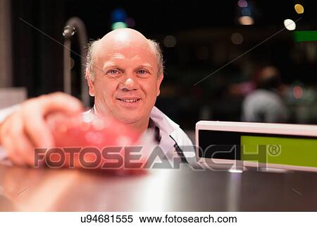 Stock Photography - Butcher weighing meat. Fotosearch