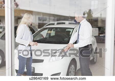 Car salesman showing car to customer View Large Photo Image Stock Photo - Car salesman showing car to customer. Fotosearch