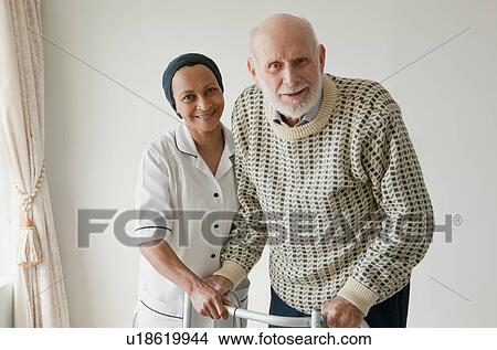 Caretaker helping older man with walker View Large Photo Image Picture - Caretaker helping older man with walker. Fotosearch