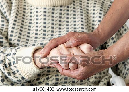 Caretaker patting older man's hand View Large Photo Image Stock Image - Caretaker patting older man's hand. Fotosearch