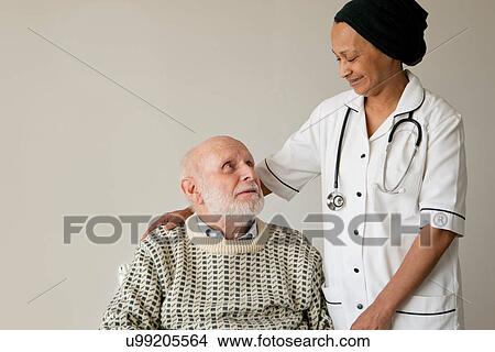 Picture - Caretaker smiling with older man. Fotosearch