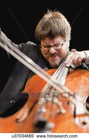 Stock Photo - Cello player in orchestra. Fotosearch
