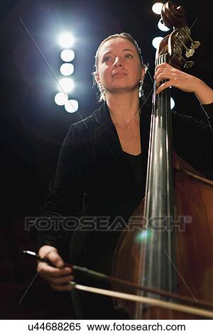 Stock Photography - Cello player in orchestra. Fotosearch