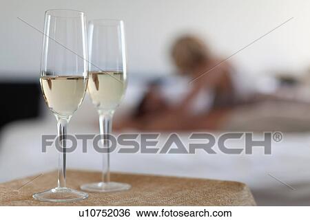 Stock Photograph - Champagne glasses in bedroom. Fotosearch