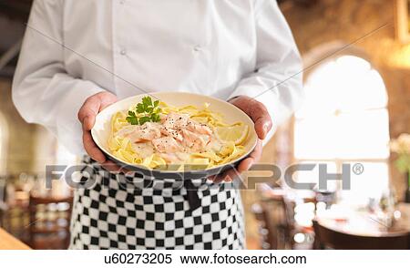 Chef holding dish of fresh tagliatelle with Scottish smoked salmon View Large Photo Image Stock Photography - Chef holding dish of fresh tagliatelle with Scottish smoked salmon. Fotosearch