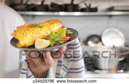 Chef holding omelet with Scottish smoked salmon, salad and lemon slice in restaurant View Large Photo Image Stock Photograph - Chef holding omelet with Scottish smoked salmon, salad and lemon slice in restaurant. Fotosearch
