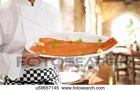 Chef in restaurant holding hand-reared Scottish smoked salmon View Large Photo Image Stock Photography - Chef in restaurant holding hand-reared Scottish smoked salmon. Fotosearch