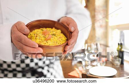 Chef in restaurnat holding traditional dish of scrambled egg and Scottish smoked salmon View Large Photo Image Stock Image - Chef in restaurnat holding traditional dish of scrambled egg and Scottish smoked salmon. Fotosearch
