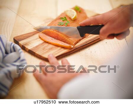 Chef using knife to slice Scottish smoked salmon on board View Large Photo Image Stock Image - Chef using knife to slice Scottish smoked salmon on board. Fotosearch