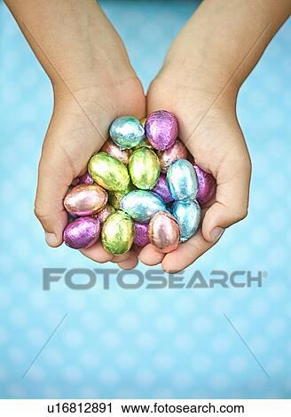 Child holding chocolate eggs View Large Photo Image Stock Image - Child holding chocolate eggs. Fotosearch