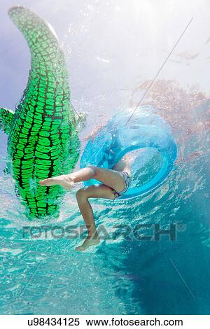 Child playing with floating toys in pool View Large Photo Image Stock Photography - Child playing with floating toys in pool. Fotosearch