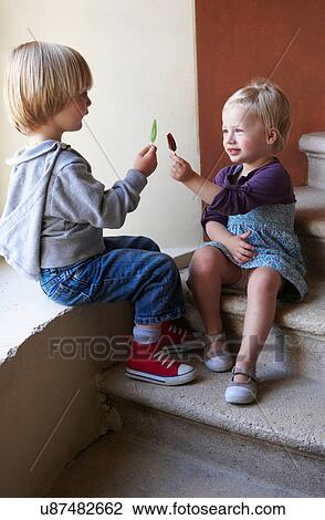 Stock Image - Children comparing popsicle sticks. Fotosearch