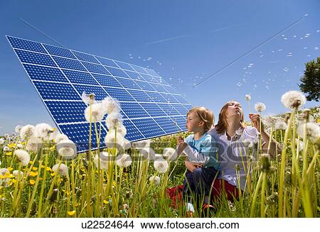 Picture - Children in field with solar panels. Fotosearch