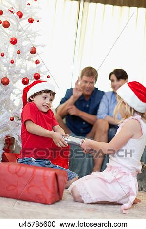 Children opening Christmas cracker View Large Photo Image Stock Image - Children opening Christmas cracker. Fotosearch