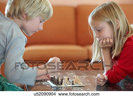 Children playing chess in living room View Large Photo Image Picture - Children playing chess in living room. Fotosearch