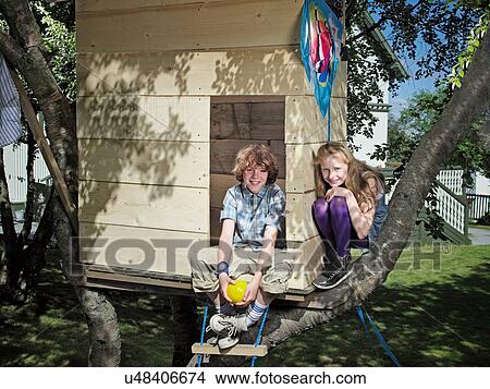 Picture - Children playing in treehouse. Fotosearch