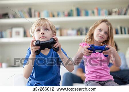Children playing video games together View Large Photo Image Stock Image - Children playing video games together. Fotosearch