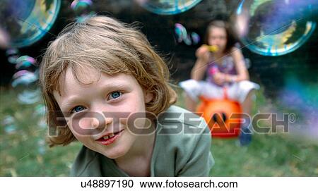 Children playing with bubbles outdoors View Large Photo Image Stock Image - Children playing with bubbles outdoors. Fotosearch
