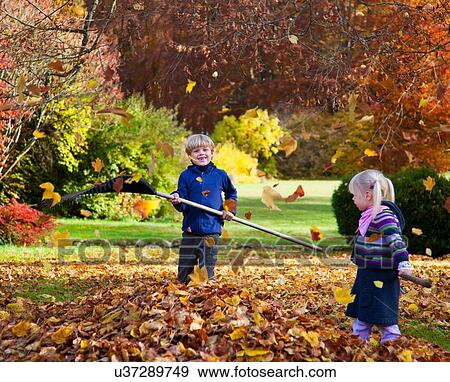 Children raking fall leaves View Large Photo Image Stock Photo - Children raking fall leaves. Fotosearch