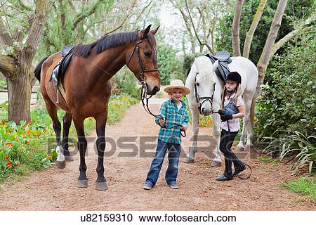 Children walking horses in park View Large Photo Image Stock Image - Children walking horses in park. Fotosearch
