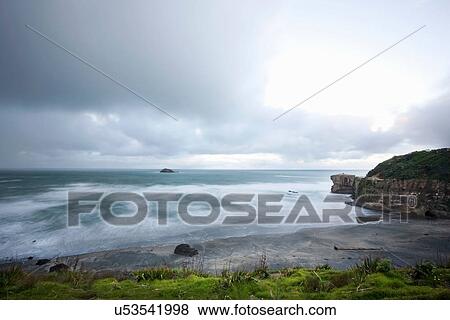 Stock Photo - Cliffs jutting into ocean. Fotosearch