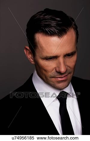 Close up of businessman's frowning face View Large Photo Image Stock Photography - Close up of businessman's frowning face. Fotosearch