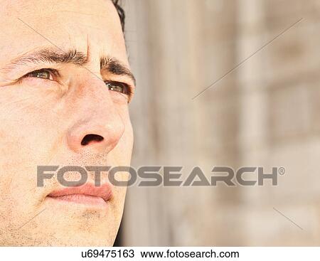 Stock Image - Close up of businessman's serious face. Fotosearch