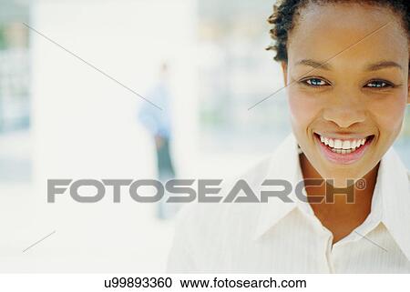 Stock Image - Close up of businesswoman's smiling face. Fotosearch