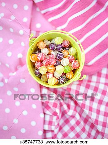 Stock Photo - Close up of candies in bucket. Fotosearch