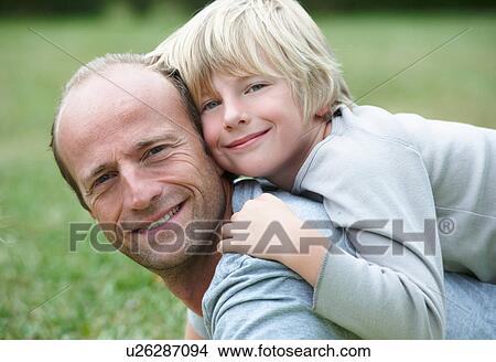 Picture - Close up of father and son smiling. Fotosearch