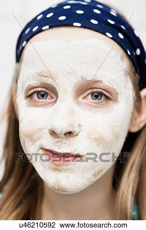 Close up of girl using face mask View Large Photo Image Stock Image - Close up of girl using face mask. Fotosearch