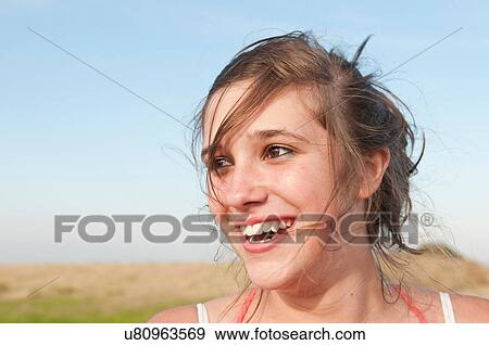 Stock Photo - Close up of girl's smiling face. Fotosearch