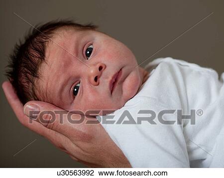 Stock Image - Close up of infant's face. Fotosearch