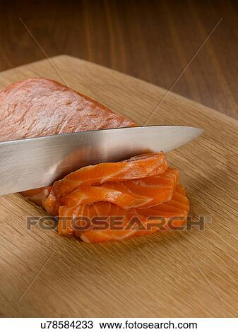 Close up of knife slicing salmon View Large Photo Image Stock Image - Close up of knife slicing salmon. Fotosearch