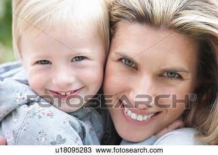 Stock Image - Close up of mother and child smiling. Fotosearch